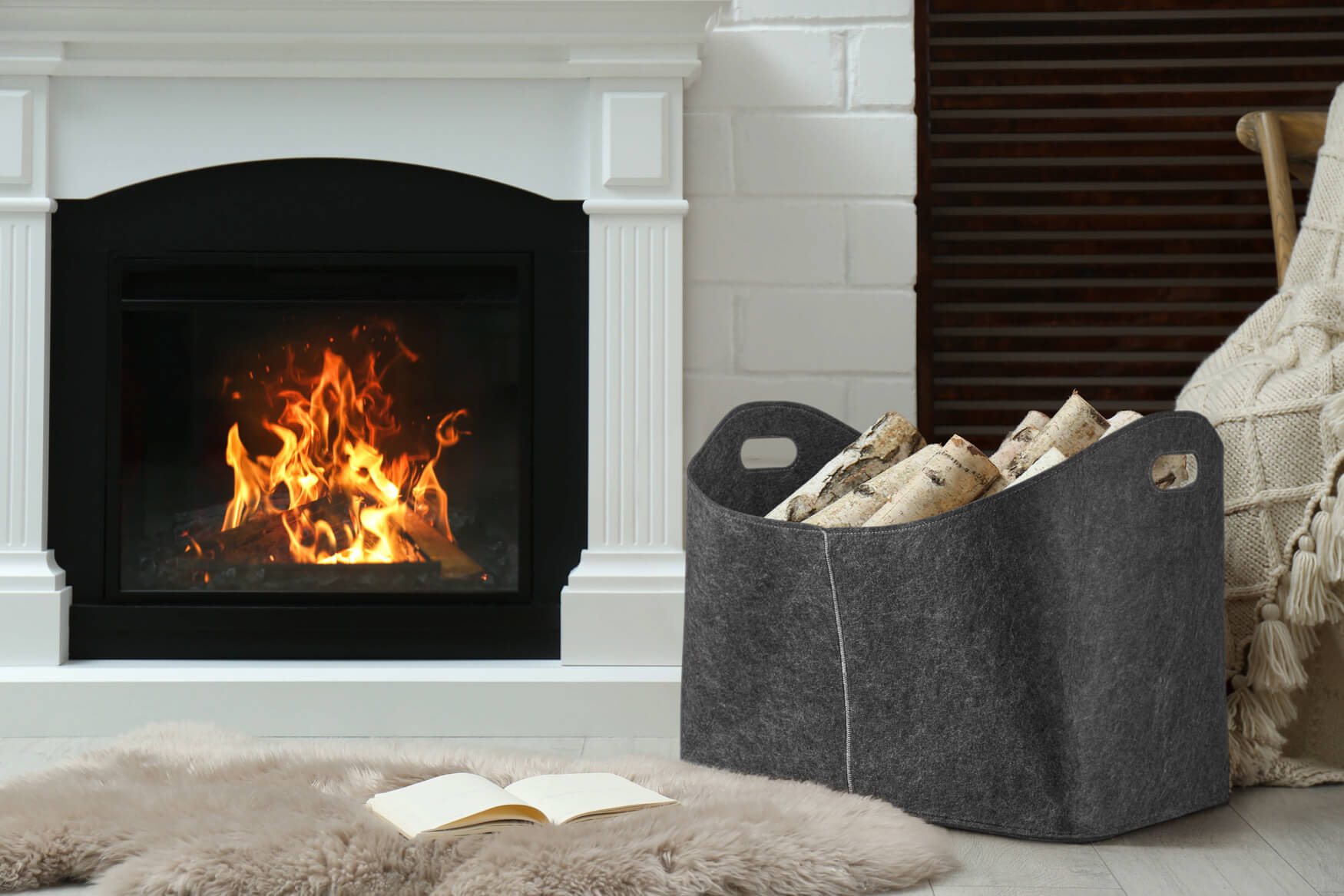Entdecke die Wärme eines Filzholzkorbs vor einem knisternden Kamin, begleitet von einem flauschigen Fell und einem Buch – alles perfekt arrangiert für einladende Wohnatmosphäre
